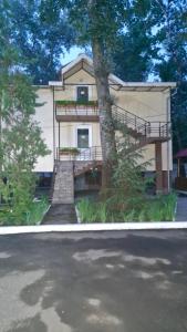 a house with a tree in front of it at Air-Moldova Dacia in Chişinău