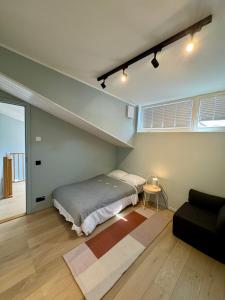a bedroom with a bed and a couch at Saue Apartment in Haapsalu