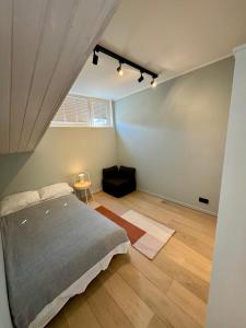 a bedroom with a bed and a couch in it at Saue Apartment in Haapsalu