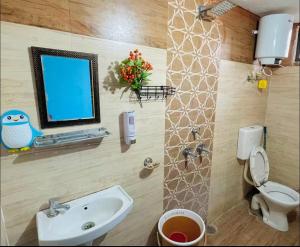 a bathroom with a sink and a computer on a wall at Cozy Corner by Tulsi Homestay in Haldwāni +7 photos