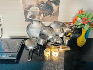 a bunch of pots and pans on a kitchen counter at Cozy Corner by Tulsi Homestay in Haldwāni
