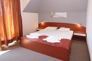 a bedroom with a bed with towels on it at Guesthouse Kirov in Ravda +53 photos