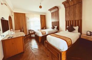 Postel nebo postele na pokoji v ubytování Hotel The Kantipur