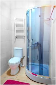 a bathroom with a toilet and a glass shower at Hotel Dalida in Tbilisi City
