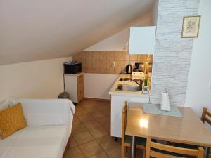 a kitchen and dining room with a couch and a table at Apartments Stana in Sukošan