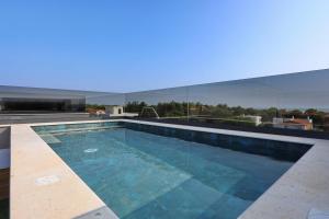 a swimming pool on top of a building at K2-Penthouse with sea view and heated pool in Vir