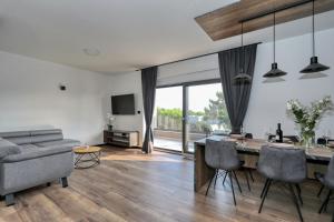 a living room with a dining table and a couch at K2-Penthouse with sea view and heated pool in Vir +48 photos