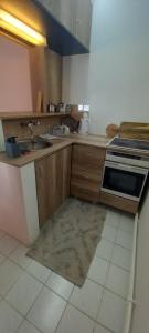a kitchen with a sink and a stove at PIAR in Subotica