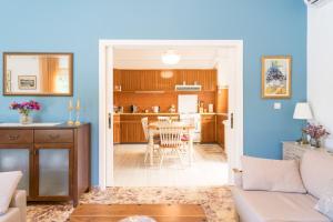 a living room and kitchen with a table and chairs at Zina's Aqua Retreat - Kos in Ampavris