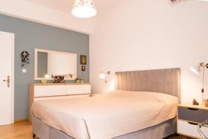 a bedroom with a large bed and a mirror at Zina's Aqua Retreat - Kos in Ampavris +10 photos