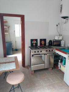 a kitchen with a stainless steel stove and a table at Bonita Casita Luz del Sol in Arboleas