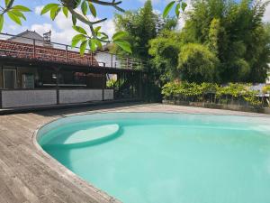 a large blue swimming pool next to a building at Cove Wong Village in Tumbak Bayuh