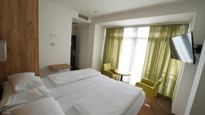 Postel nebo postele na pokoji v ubytování Hotel Tesla