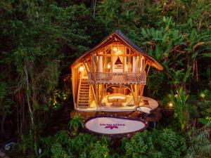 a small tree house in the middle of a forest at Jiva Bali - Green Dream in Selat
