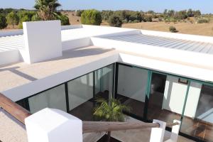 a white house with glass windows and a bench at Monte da Figueira Brava in Aldeia dos Ruins +34 photos