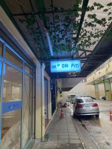 a parking lot with a car parked in a parking garage at Moon Pīti in Bangkok +21 photos