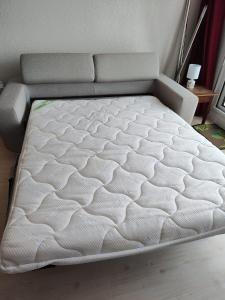 a bed in a room with a white mattress at Studio vue mer - La Turballe in La Turballe