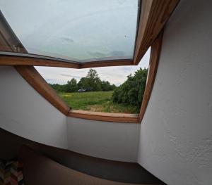 a window in a room with a view of a field at Miejski Las 8 in Mrągowo
