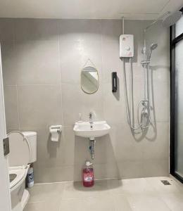 a bathroom with a shower and a sink and a toilet at Moon Pīti in Bangkok