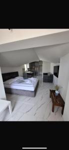 a bedroom with a large bed and a table at H&H Rooms Rovinj - Adults Only in Rovinj