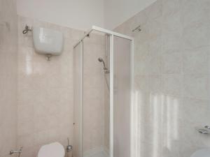 a bathroom with a shower with a toilet and a sink at Stunning Farmhouse in Passignano with Pool in Passignano sul Trasimeno +125 photos