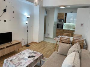 a living room with a couch and a table at Golden 25 Skopje in Skopje