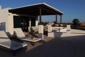 a group of chairs on the roof of a building at Monte da Figueira Brava in Aldeia dos Ruins