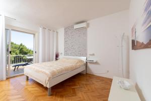 Postel nebo postele na pokoji v ubytování Apartments Dobronic