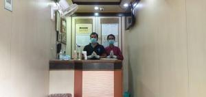 two people wearing face masks in a subway train at Hotel O Mega Palace in Patna +37 photos