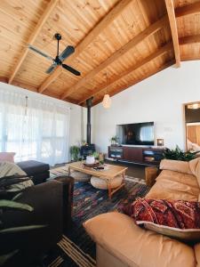 a living room with a couch and a table at Myrtle Casa in Mount Beauty