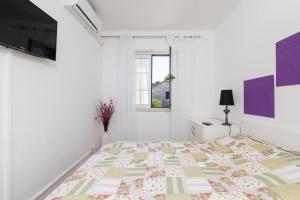 Postel nebo postele na pokoji v ubytování Apartments Dobronic