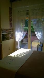 a bedroom with a bed and a window with curtains at B&B Metrò in Bussero