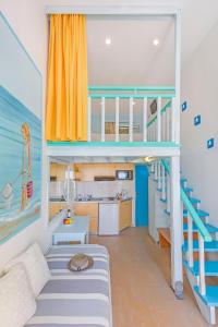 a room with a bunk bed and a staircase at Haraki De Sol Beach Apartments in Haraki