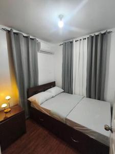 a bedroom with a bed and a window with curtains at Casa Solana in Dao