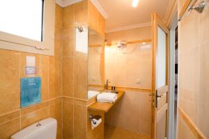 a bathroom with a toilet and a sink at SALTY BREEZE Beachfront Apartment in Lygia
