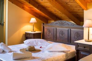 a bedroom with a large bed with a wooden headboard at SALTY BREEZE Beachfront Apartment in Lygia