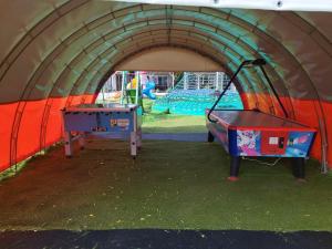 a play tent with a ping pong table in it at Holiday Homes 777 in Karwia