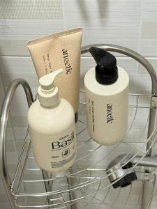 two bottles of laundry detergent sitting on a shelf at Stay Meomoolda in Seoul