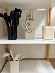 a shelf with knives and utensils on it at Stay Meomoolda in Seoul
