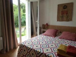 a bedroom with a bed and a sliding glass door at Casa di Ceppo in Patrimonio +12 photos