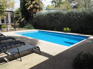 a swimming pool with two lounge chairs next to it at The Brewers House in Beechworth