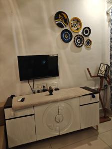 a living room with a tv on a wall at Sunils villa with private pool, Machan and play area in Karjat in Karjat +38 photos