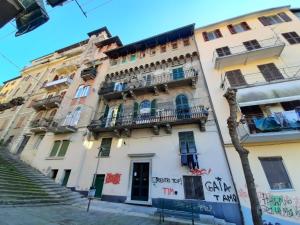 a building with balconies and stairs in a city at La Bandiera Blu in La Spezia