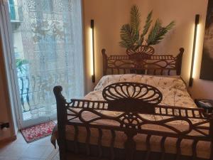 a bedroom with a bed and a window with a curtain at La Bandiera Blu in La Spezia