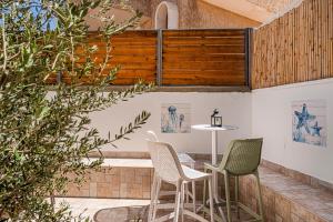 a patio with two chairs and a table at הקונכייה in Eilat