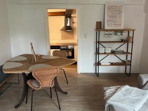 a dining room table and chairs in a living room at Fachwerk Rustikal in Melsungen