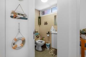 a bathroom with a toilet and a sink at הקונכייה in Eilat +27 photos