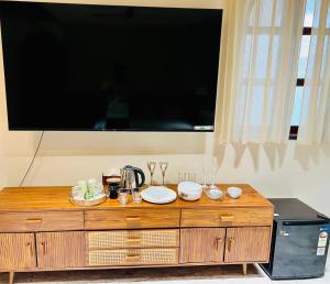 a large flat screen tv on top of a wooden dresser at Misty BNB And Homestay in Jaipur