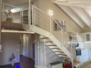 a staircase in a living room with a stair case at Attico 800 in Castiglion Fosco