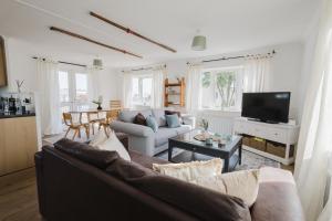 a living room with a couch and a table at Restful Riverside Retreat in Christchurch